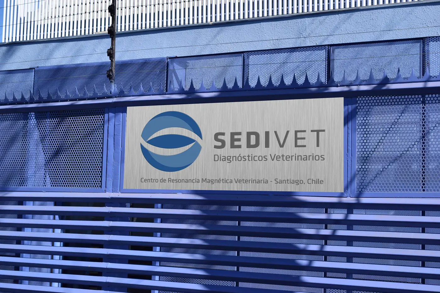 Sedivet sign on the façade of the center, over a blue fence
